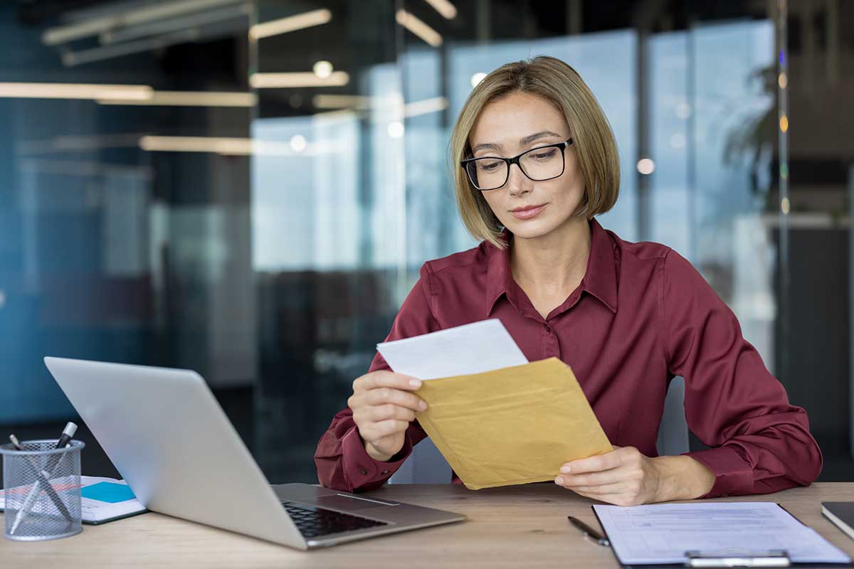 debt recovery photo woman opening a letter